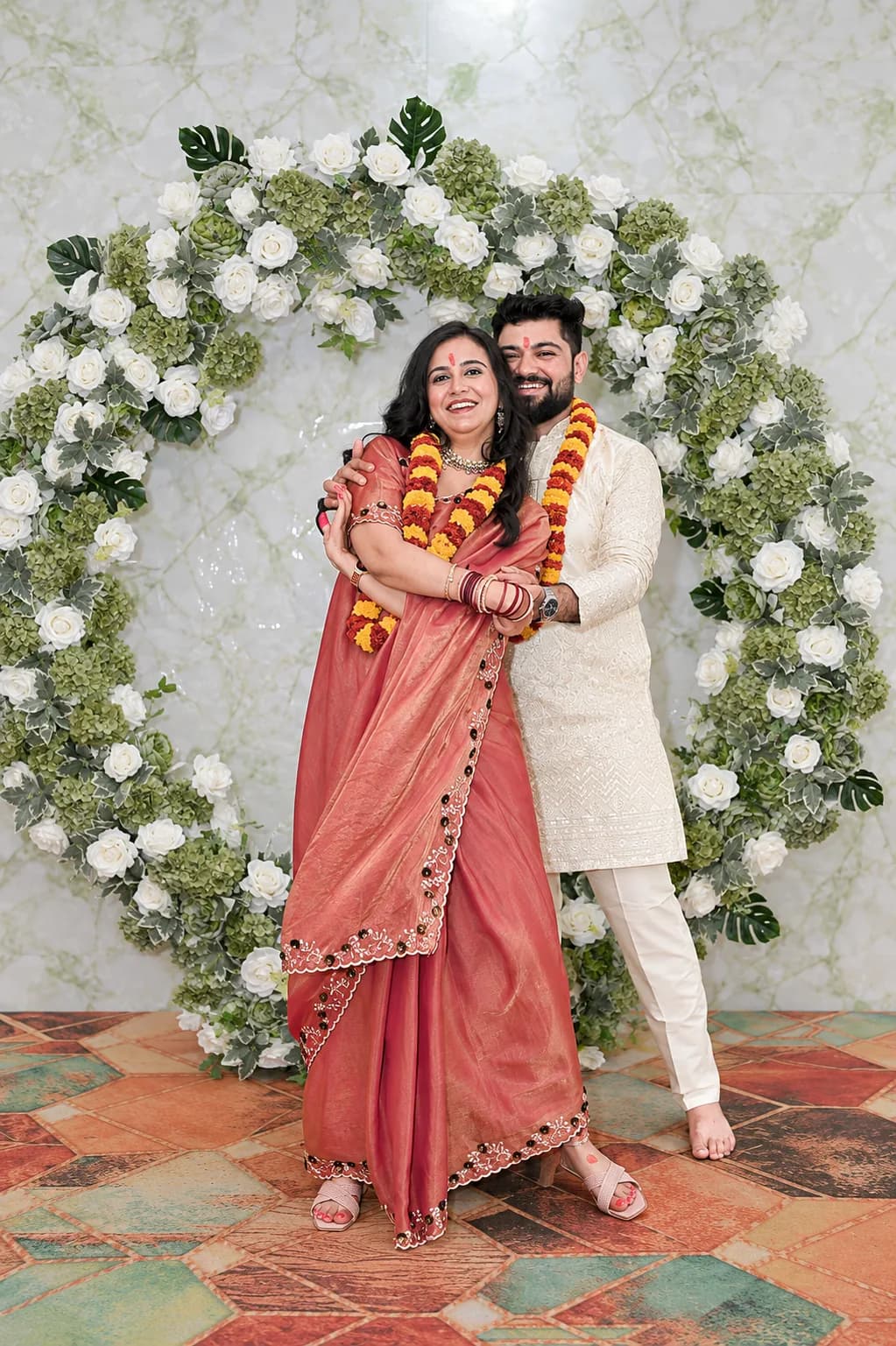 Yogesh and Akanksha celebrating with marigold garlands